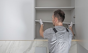 contractor adding storage in a bathroom remodel