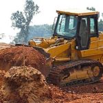 a bulldozer carrying fill dirt for a project