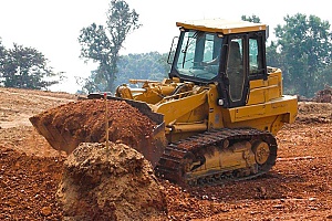 a bulldozer carrying fill dirt for a project