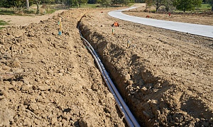 ditches being build near a road using fill dirt