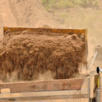 fill dirt being loaded onto a truck