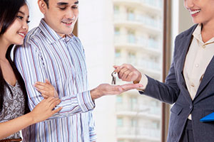 Property manager handing keys to qualified tenants for rental