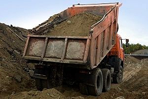 a truckload carrying many cubic yards of dirt