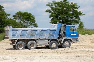 blue dump truck in Vienna, VA hauling a load of fill dirt