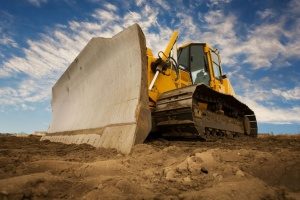 bulldozer at a Manassas, VA construction site scooping up fill dirt