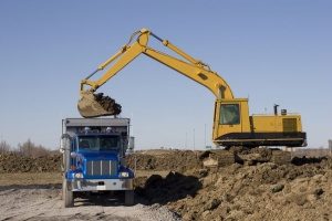 excavator filling a dump truck in Falls Church, VA with fill dirt