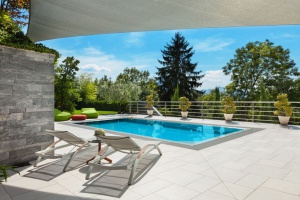beautiful backyard with an inground swimming pool built into the patio