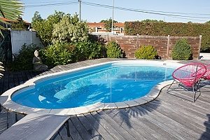 private pool fenced off using retaining walls where the foundation for both the pool and walls compose of fill dirt