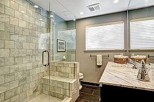 a brand new Fairfax bathroom remodeling projct that includes a walk-in brick shower and a modern sink