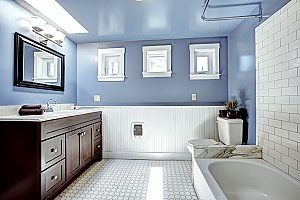 freshly painted walls in the color blue by a Fairfax bathroom remodeling contractor who also installed a new combined shower and tub fixture