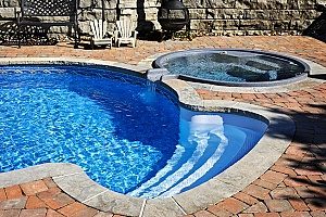 a pool in the backyard of a Fairfax, VA home that will receive pool removal services by a pool removal contractor since the owners do not want to do it themselves