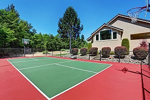 fully installed basketball court in the backyard of a homeowner that just recently received a Maryland fill dirt delivery to flatten out the land that supports the court