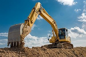 a contractor using an excavator and working on a commercial construction site while using Virginia fill dirt