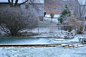 a fallen cover for an inground pool in Fairfax, VA that has broken the layer of ice, inviting bacteria into the swimming pool