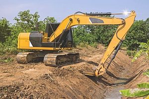 an excavator working with clean fill dirt to dig out a pipeline for a home in Fairfax, VA