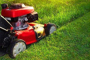 a homeowner mowing the lawn which is one of the ways how to prepare your lawn for spring