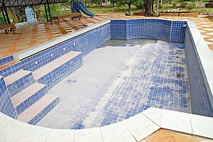 a swimming pool that has been drained before a spring pool removal