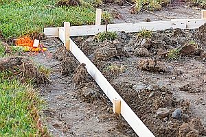 stakes in the ground to mark where front yard retaining walls will be marked