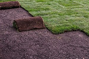layers of sod removed from a backyard where an artificial turf putting green will be placed
