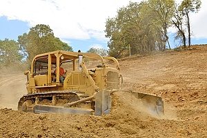 a bulldozer working with different types of fill dirt at a construction site