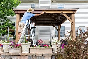 a man installing a gazebo in his backyard after pool removal services