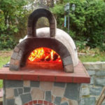 an outdoor pizza oven built by a homeowner