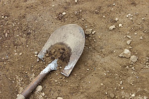 a shovel on top of dirt in the backyard of a Virginia homeowner who plans to build a circular stone island