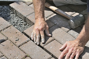man building patio floor to prepare for outdoor kitchen