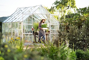 woman in her backyard greenhouse