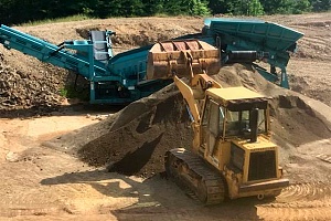 a bulldozer attempting to build up dirt around foundation