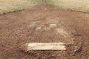 a dirt pitching mound that was built in a backyard
