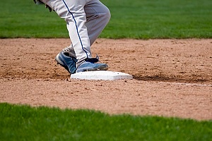 a kid running toward home plate on a baseball field