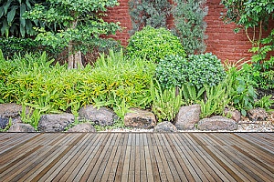 a rock garden next to a ground level deck which is supported by fill dirt