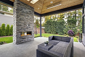 the backyard of a homeowner who learned how to build an outdoor fireplace