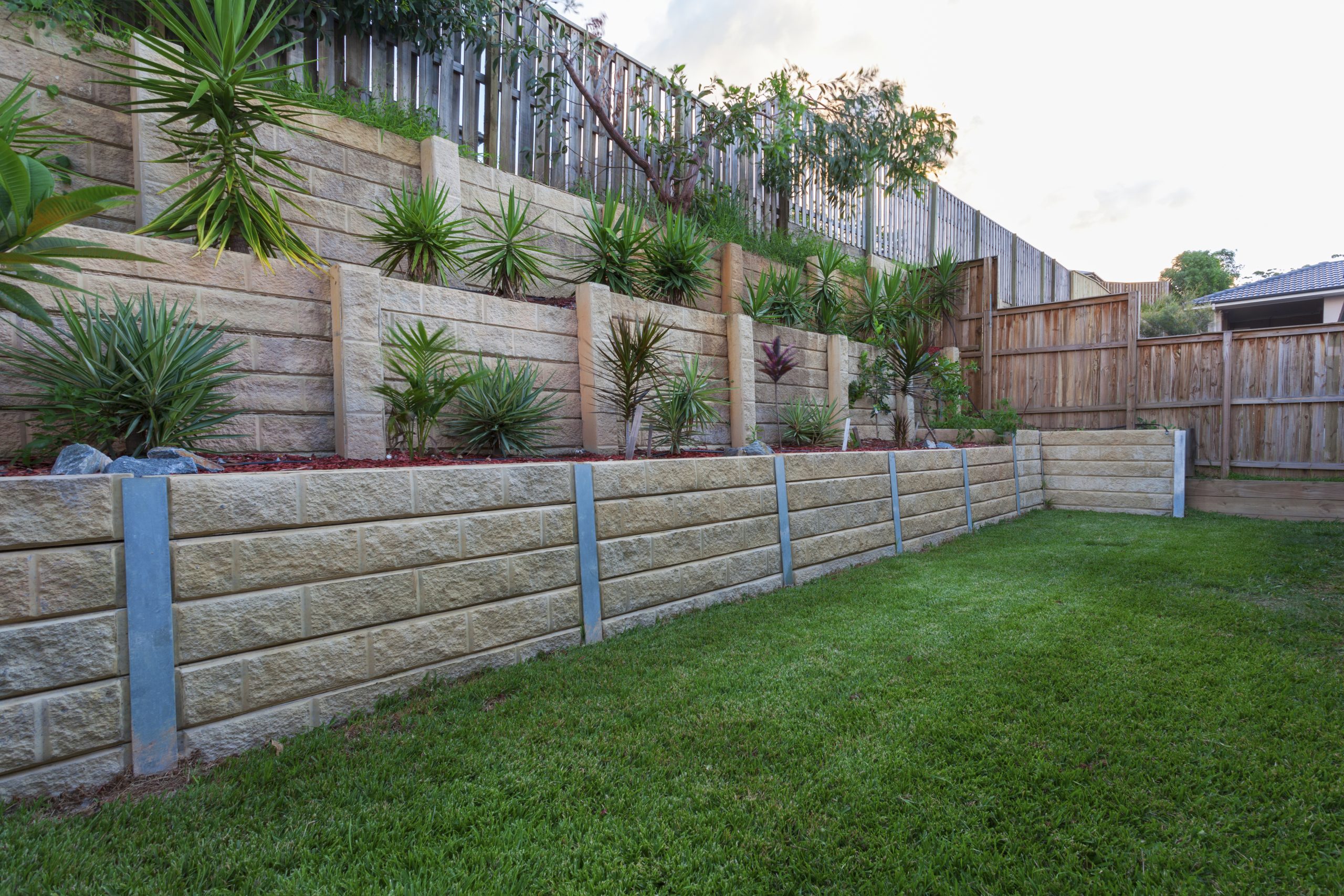 Multi tiered newly constructed retaining wall.