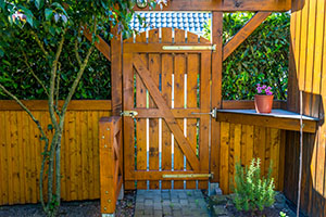 Wooden gate and fence on the back of the home garden