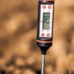 a-tool-inserted-into-soil-that-checks-the-acidity-of-the-soil