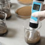 Measuring soil acidity and pH level in a soil testing lab