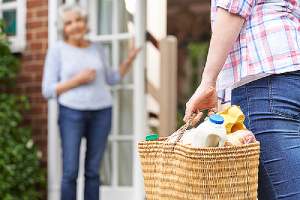 A Person helping his elderly neighbor. Communicating early and often with your neighbors about your home addition plan