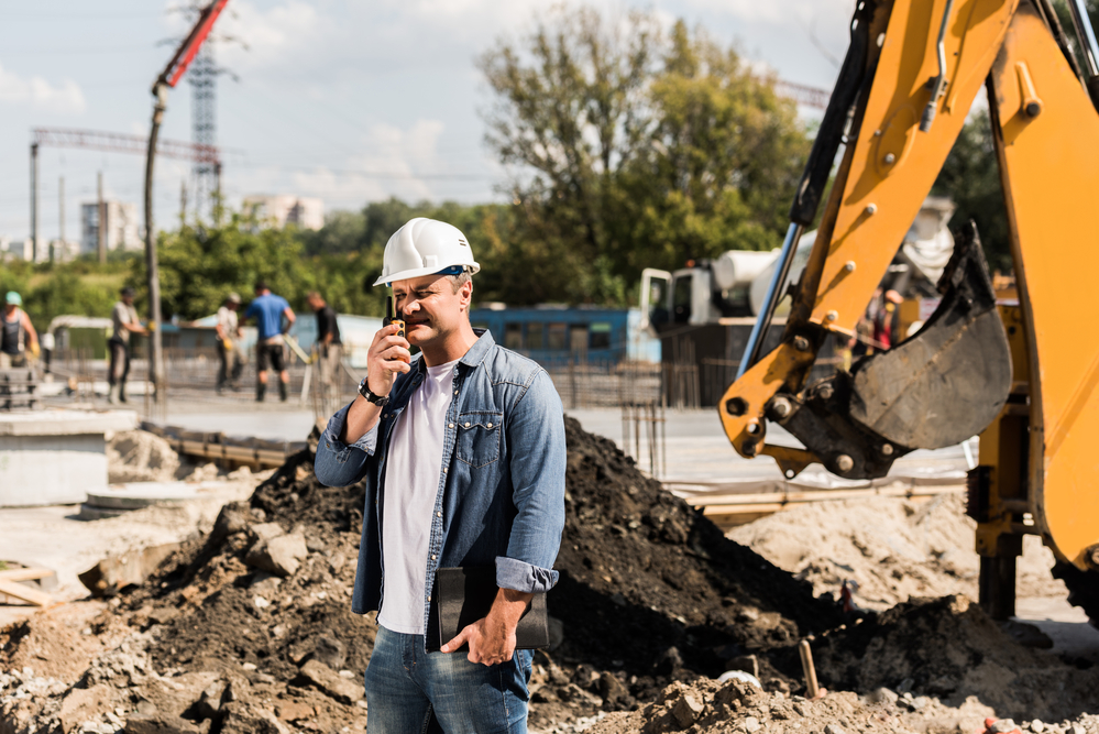 a construction project manager talking on the phone