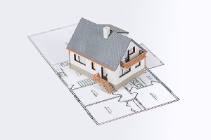Model house of a custom home addition project on a blueprint