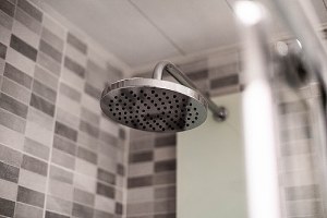 A bathroom shower head. Many homeowners decide to carry out a bathroom remodel when signs of wear starts showing