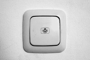 A white color light switch. There are major steps involved in carrying out a bathroom remodeling project