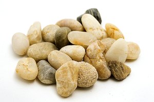 A heap of smooth pea gravel. Pea gravel is a very popular choice for the top layer