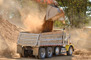 dump truck getting loaded with unscreened fill dirt