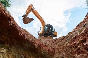 Excavator digging a trench. There are affordable methods of fill dirt removal