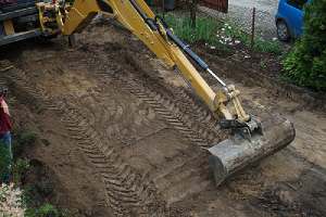 Land grading by an excavator