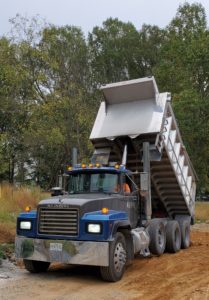 triaxle dump truck delivering structural fill dirt by dirt connections