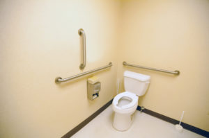 ada clean public toilet with grab bars for handicapped