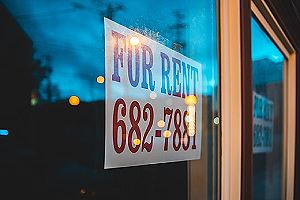 For rent sign on window pane. A home addition can also serve as a way to bring in additional income
